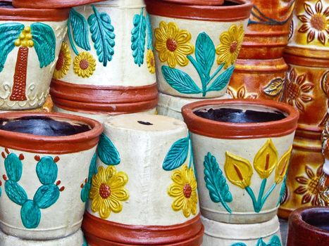 Colorful flowerpots stacked at Mexican market