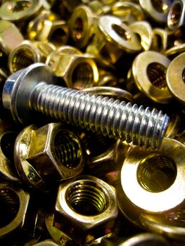 A bolt in lots of brass nuts