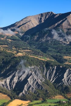 Beautiful landscape with mudslides in the bottom part, located in the Southern French Alps in The Alpes-de-Haute-Provence department.