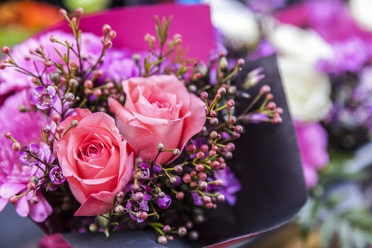 Close-up image of a beautiful flowers bouquet with two pink roses.