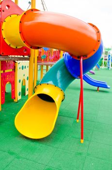 Image of a colorful children's playground in suburban area.
