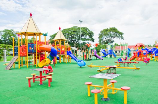 Image of a colorful children's playground in suburban area.