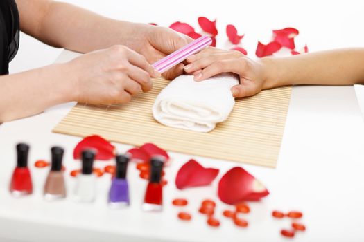 Young woman is getting manicure in a beauty salon