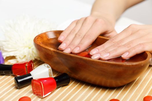 Young woman is getting manicure in a beauty salon