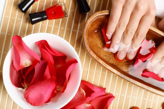 Young woman is getting manicure in a beauty salon