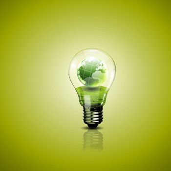 Electric light bulb and a plant inside it as symbol of green energy