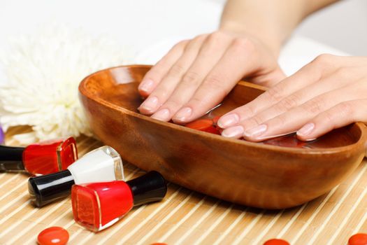 Young woman is getting manicure in a beauty salon