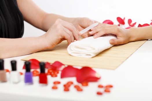 Young woman is getting manicure in a beauty salon