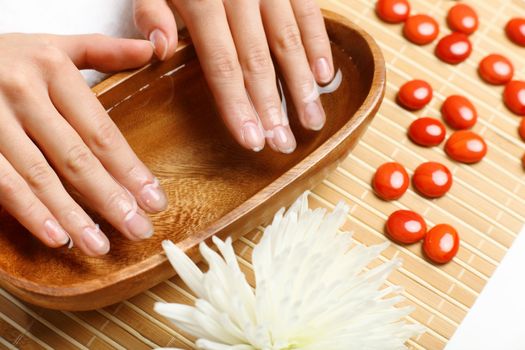 Young woman is getting manicure in a beauty salon