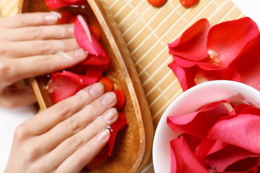 Young woman is getting manicure in a beauty salon