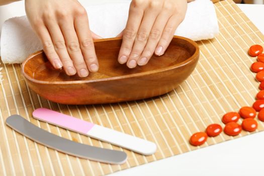 Young woman is getting manicure in a beauty salon