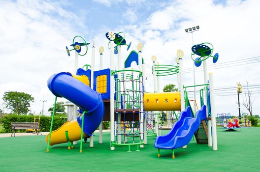 Image of a colorful children's playground in suburban area.