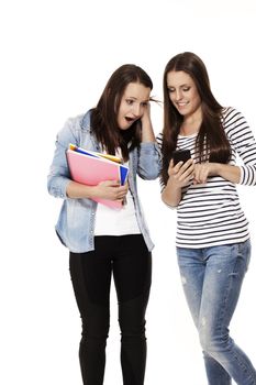 two teenage students are excited about their smartphone content  on white background