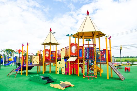 Image of a colorful children's playground in suburban area.