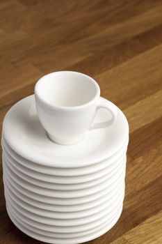 Coffee cup on the stack of saucers.