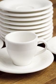 Coffee cup and the stack of saucers.