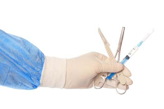 syringe, scalpel and clamp in the hand of the surgeon during a surgery