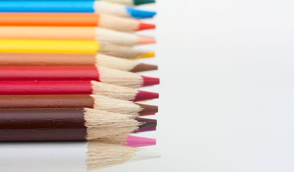 Photo of color pencils isolated in white background.