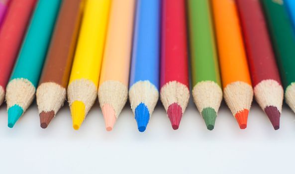 Photo of color pencils isolated in white background.