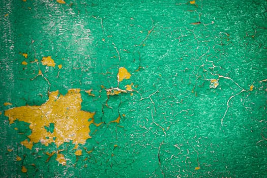 painted green wall cracked paint. The texture of old wall