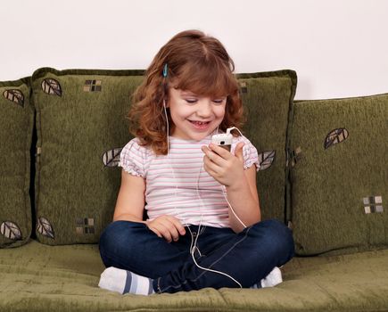 happy little girl listening music