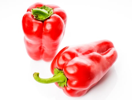Two big red peppers isolated on white background