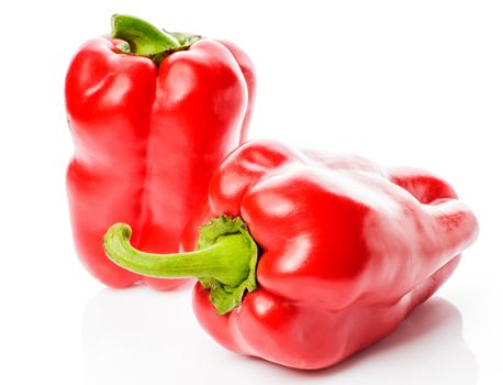 Two big red peppers isolated on white background