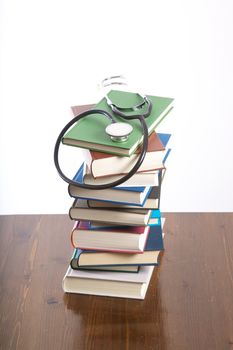 group of books piled on table and white background