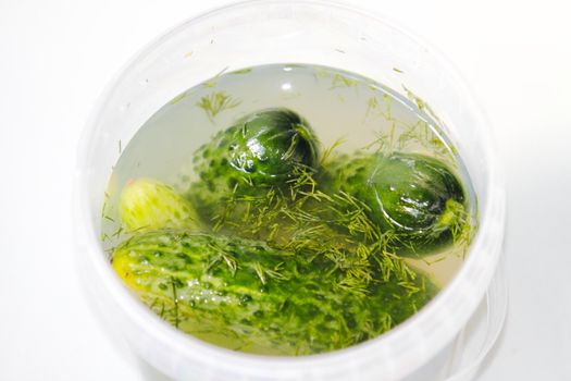 Beautiful, delicious cucumber in brine on a light background