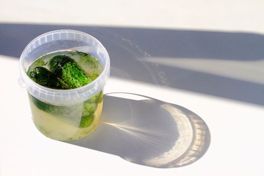 Beautiful, delicious cucumber in brine on a light background