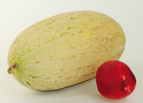 Beautiful, tasty melon, peaches on a light background