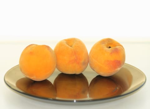 beautiful, delicious peaches on a light background