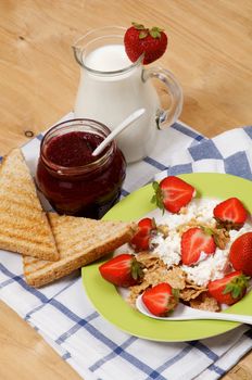 Light Breakfast of Toasts, Strawberries, Jam, Milk and Curds close up on wooden background