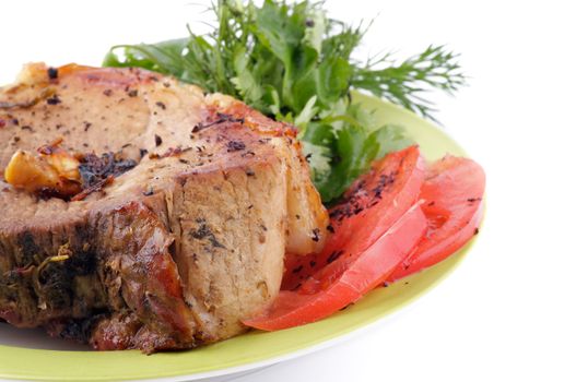 juicy Pork Chop with Tomatoes and Dill on plate isolated on white background