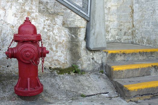 Red Fire Hydrant by the Staircase with Grunge Textured Wall Background