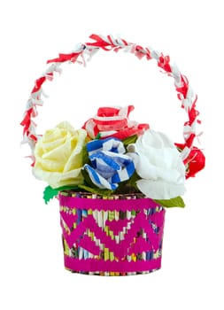 Artificial colorful paper roses in basket isolated on white background. Handmade home decoration.