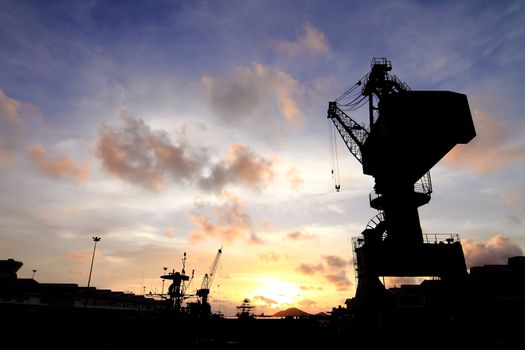 Cranes in dockside at sunset