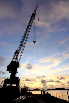 Cranes in dockside at sunset