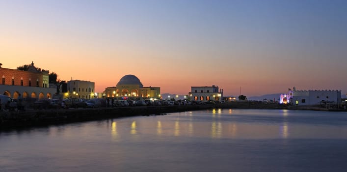 Mandraki Harbour at sunset with Turkish coast line in the back ground