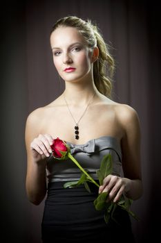 Attractive woman holding a rose on Valentine's day,