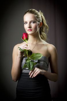 Attractive woman holding a rose on Valentine's day,