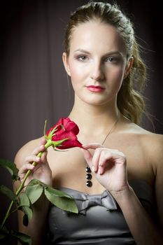 Attractive woman holding a rose on Valentine's day,