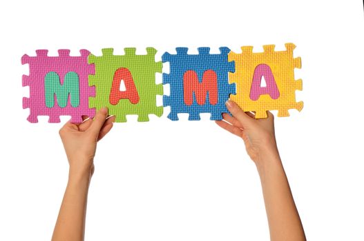 teacher holding in the hand the amusing colored educational puzzles with the word mama