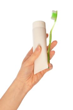 Tooth-paste and brush at in the girl's hand