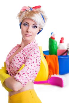 Pinup styled housewife with cleaning set on white