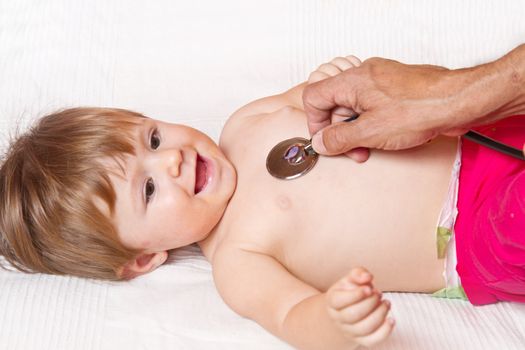 Children's doctor exams infant with stethoscope 