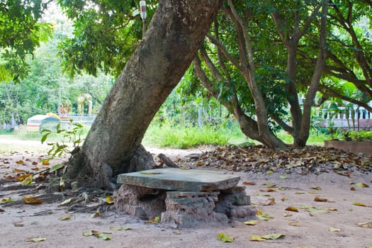 Natural stone seat in the garden. Northern Thailand.