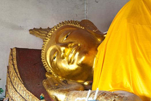 Golden Buddha in you before. Temple in Lamphun, Thailand.