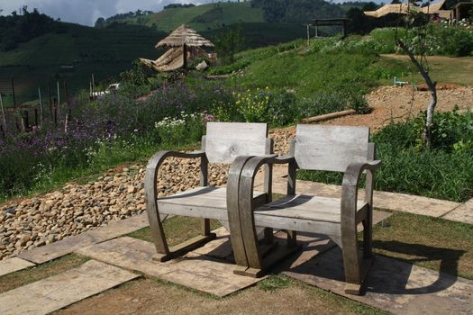 A pair of wooden chairs. High mountains in the park, I love it.