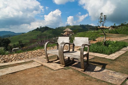 A pair of wooden chairs. High mountains in the park, I love it.